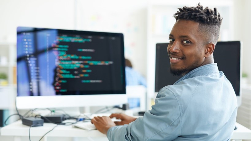 Software Developer writing code on the computer. Learn more about the Associate of Science in Software Development program today.